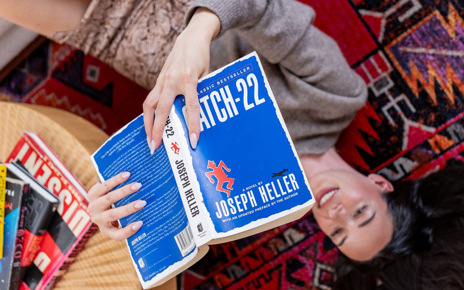 Zoey Reinach reading Catch-22 on the floor